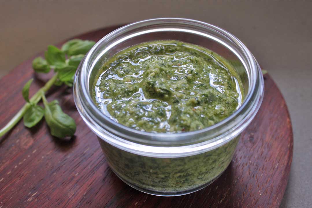 basil pesto recipe shown on chopping board - dairy free gluten free paleo